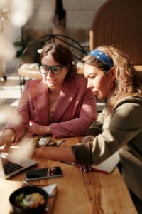 Two women working on a laptop